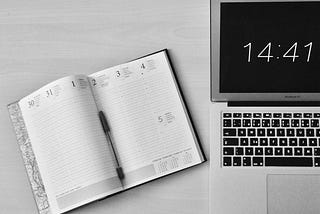 flat-lay-photography-of-unfold-book-beside-macbook