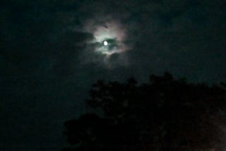 Bright full moon with green undertones.