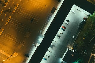 An aerial shot of a parking lot at night.