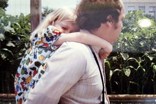 A man giving a piggy-back to a little girl.