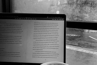 Laptop and coffee looking out the window.