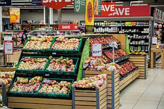 Image of supermarket stalls containing groceries.