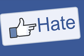 A Facebook like button modified to show a finger pointed as a gun and “Hate” instead of “Like”