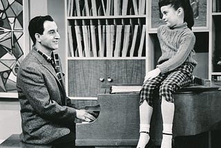 Danny Thomas plays piano for his daughter Linda, played by Angela Cartwright, seated on the piano.