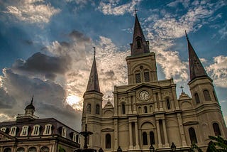 Image of Saint Louis Cathedral by Mick Haupt. Large which church and cloudy blue sky.