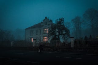 A person walking to a gloomy and lonely house
