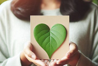 A person holding a heart-shaped leaf, symbolizing the unique gifts and purposes we each have.