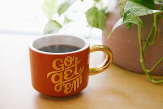 coffee mug says “go get ‘em”