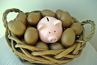 Eggs and a piggy bank in a basket.