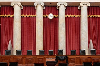 The Courtroom of the Supreme Court showing Associate Justice Ruth Bader Ginsburg’s Bench Chair in black following her death.