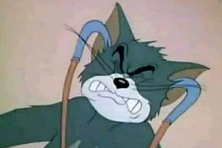 Tom the cat from Tom and Jerry cartoon, wearing stethescope and wincing in pain.