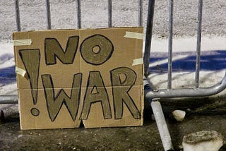 A protest sign reading ‘no war’