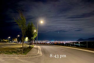 Picture of the night sky adorned with a swirl of clouds that looks like a tropical cyclone