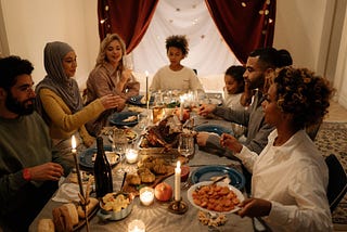 A diverse group of men, women, and a child, eating a meal together.