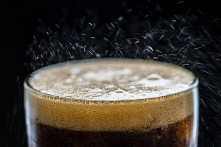 Image of a glass of Cola with thousand of bubbles as a representation of the amount of emotions that could elicits.