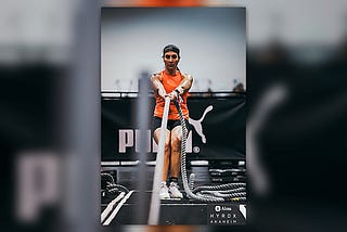 Female HYROX athlete performing sled pull rope during competition.