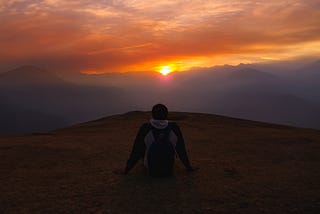 Header image of a person viewing the sunset