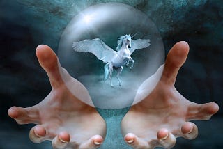 Fantastical image of giant hands cradling to hold a bubble containing a unicorn.