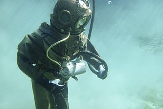 Person in Old School Green Scuba Diving Suit
