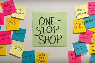 One big sticky note on a board saying ONE-STOP SHOP, surrounded by lots of smaller sticky notes