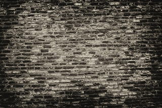 A wall of black and grey bricks