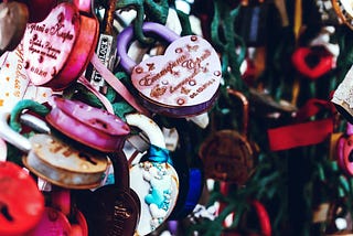 Heart-shaped lockets tied to a fence