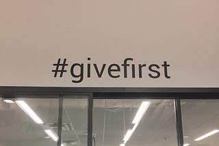 The #givefirst sticker on our co-working wall during the 2019 Techstars & Western Union Accelerator.