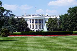 A photograph of the White House and front lawn.