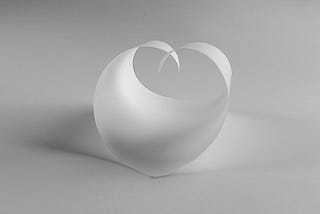 white curled paper against white background