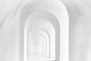 Corridor of white arches