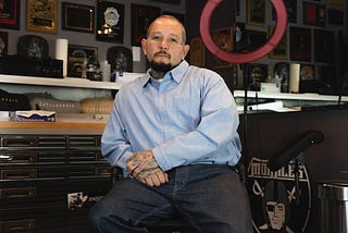 Jaime “Lazy” Morales is photographed above in 2022 at his Untouchable Tattoo studio by David William Reeve