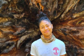 Octavia standing in front of a felled redwood in Sequoia National Park.