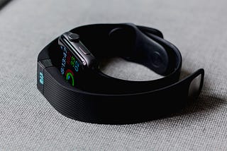 Fitbit and Apple watch on a table