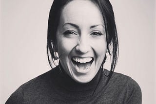 Black and white photo of a girl laughing