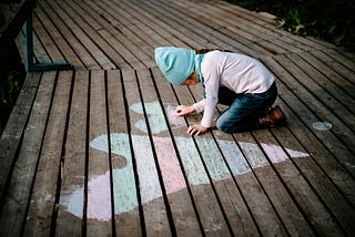a child painting hearts with a piece