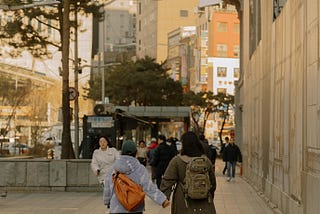 People walking on a sidewalk in a city