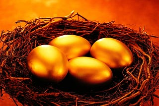 Four golden eggs in a nest