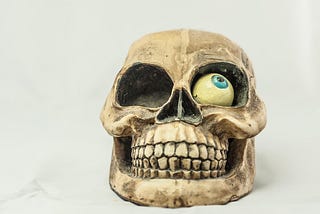 Comical smiling skull with one eye out