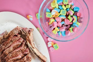 Medium-done steak and a tall glass of lucky charms.
