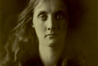 An albumen print from 1867, featuring a model gazing into the camera, almost expressionless.