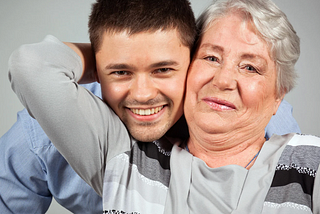 older woman hugging young man
