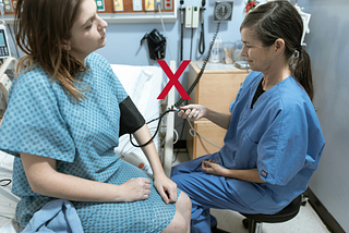 A nurse checking a woman’s BP (incorrectly) in a hospital setting