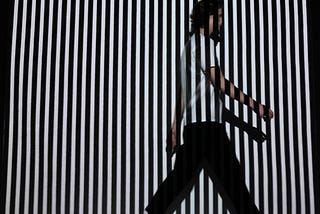 Man walking on stripes wall