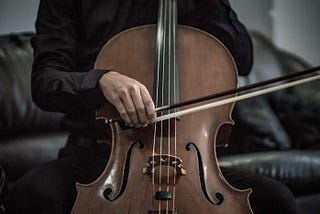 A cello being played with a bow
