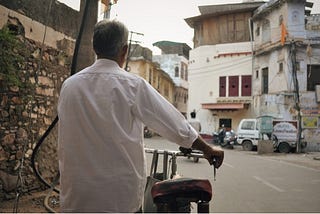 A man walks his bike down the streets of Bundi | Photo by Nicola Sousa