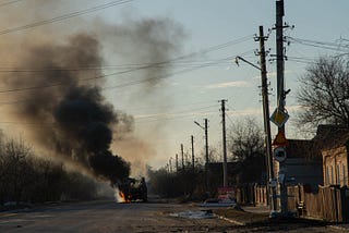 A bus burns in the early days of Russia’s invasion of Ukraine