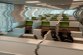 Distorted image of a group of empty cubicles in a corporate office