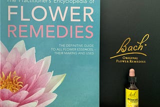 Picture of a book, a Bach flower essence case, and a bottle of Bach’s Rescue Remedy flower essence