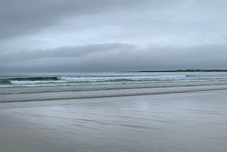 grey empty beach and grey sky.