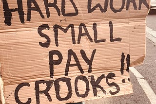 Buco Employee with his Placard. Image source: Earl Mentor, “Buco Protest,” 2024 CC-BY-NC